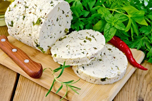Cheese homemade with hot pepper and rosemary on board — Stock Photo, Image