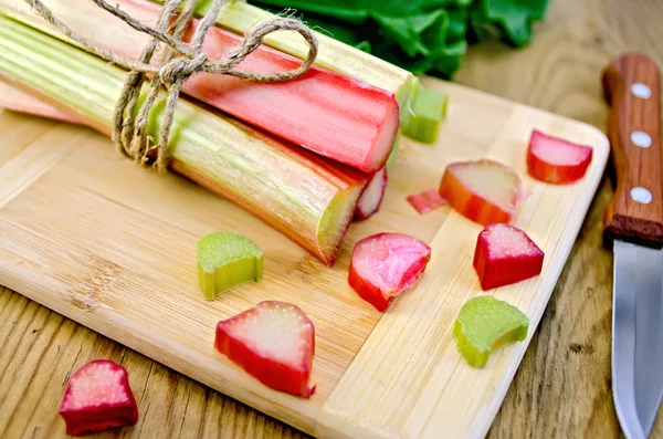 Rhubarb cut and knife on board — Stock Photo, Image