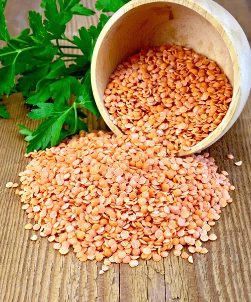 Lentils red in wooden bowl on board — Stock Photo, Image