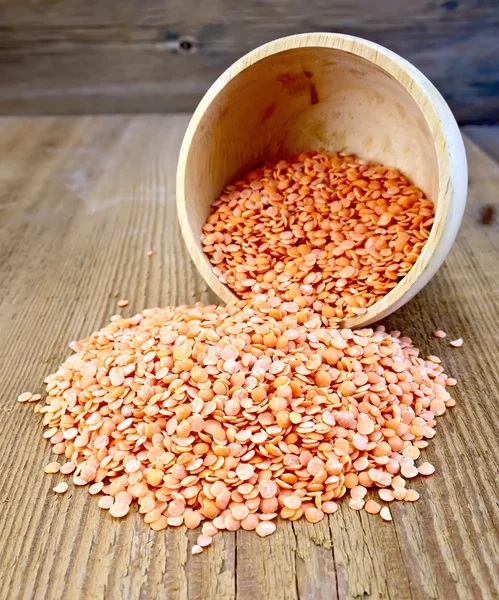 Lentils red in wooden bowl on the board — Stock Photo, Image