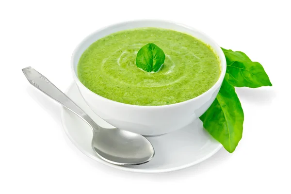 Puré de sopa con espinacas en un tazón y hojas — Foto de Stock