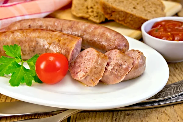 Sausages pork fried in plate on board with bread — Stock Photo, Image