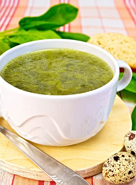 Soup of greenery on fabric with quail eggs — Stock Photo, Image