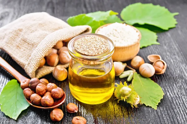 Hazelnut Oil Glass Jar Flour Bowl Nuts Bag Spoon Table — Stock Photo, Image