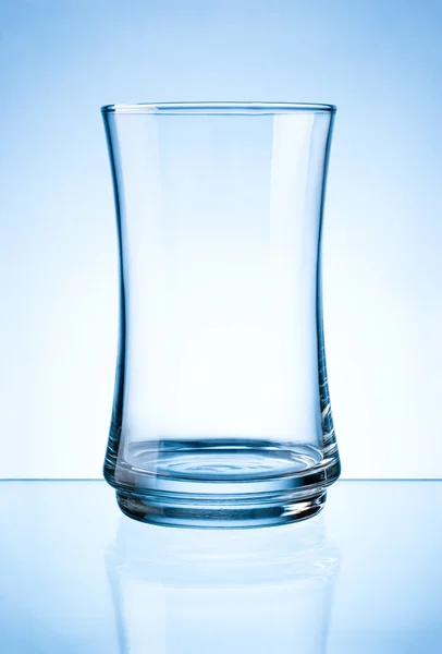 Empty glass isolated on a blue background — Stock Photo, Image