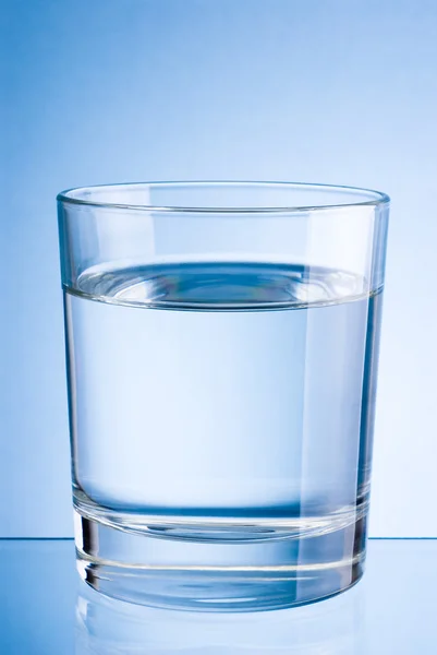 Drinking water glass on a blue background — Stock Photo, Image