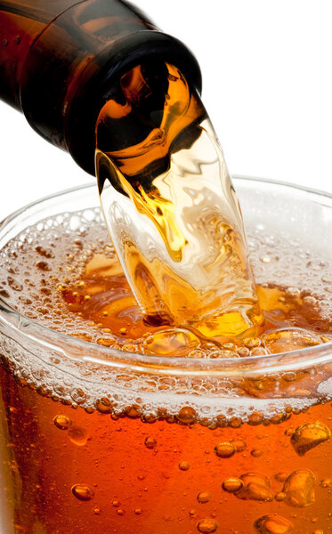 Pouring beer from bottle isolated on white background