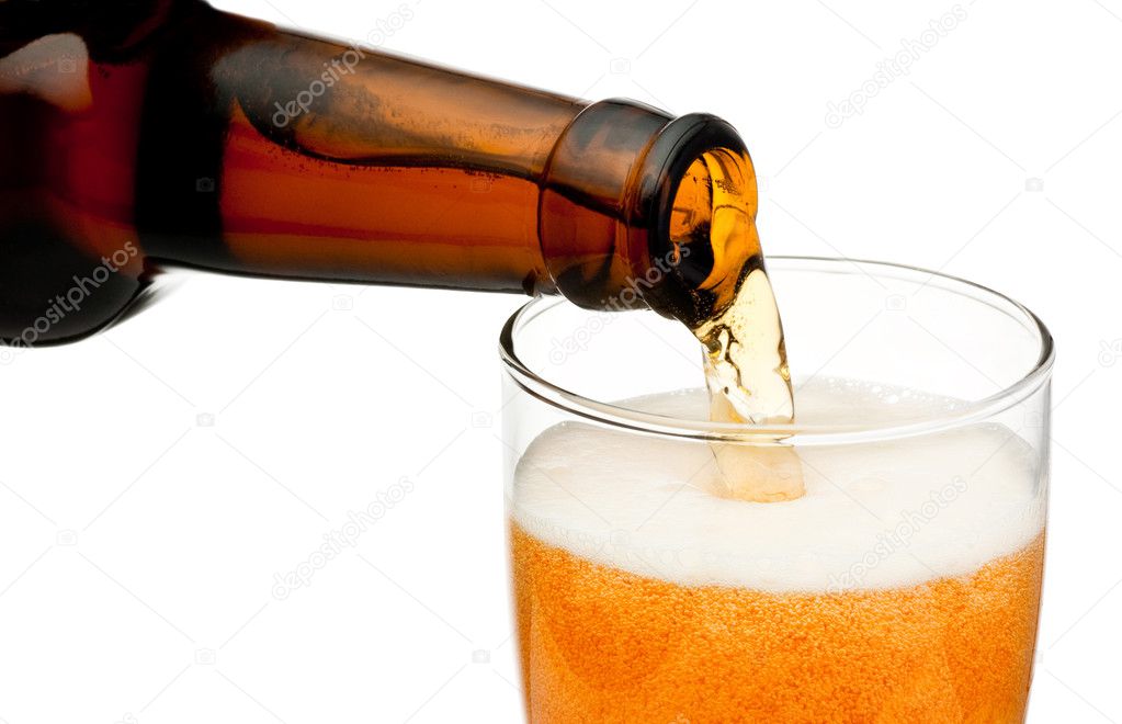 Pouring beer from bottle isolated on white background