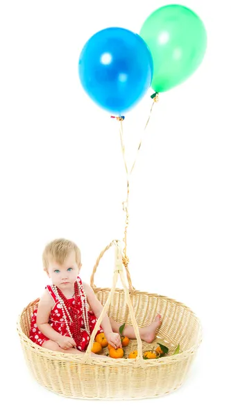 Girl sitting in a big basket — Stock Photo, Image