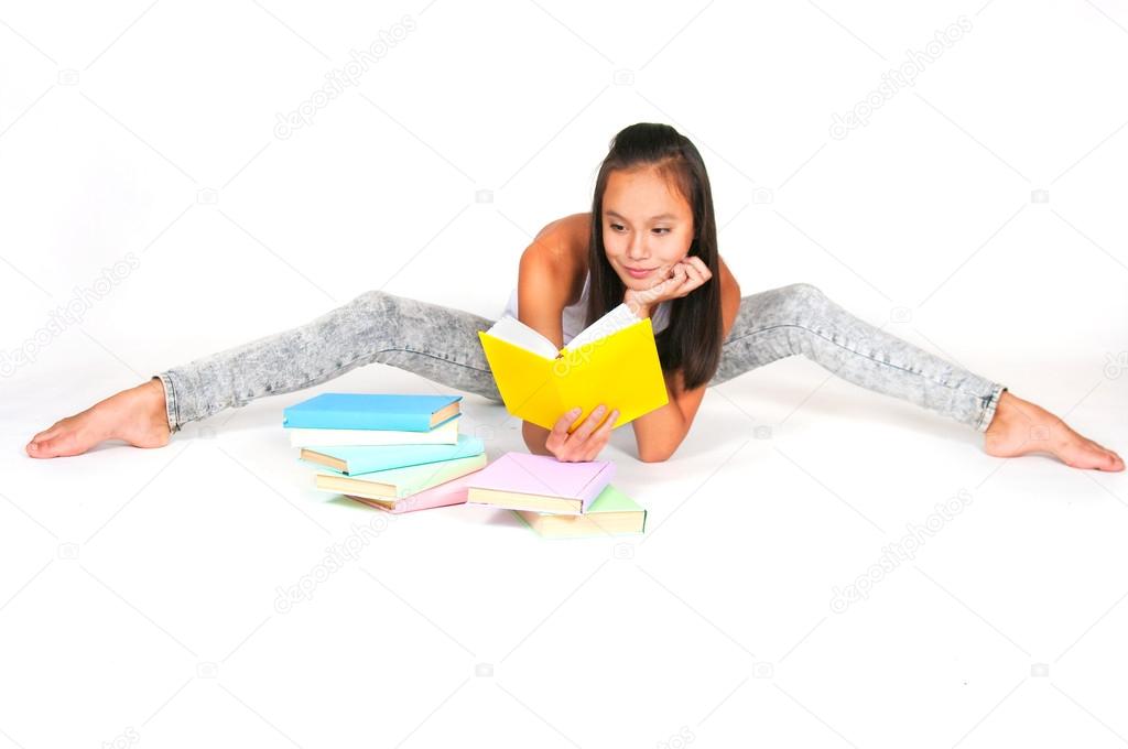 Asian teenage girl reads the book