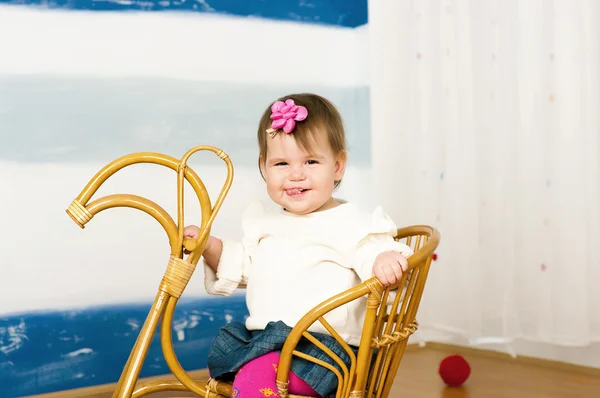 Little girl on a horse rocking chair — Stock Photo, Image