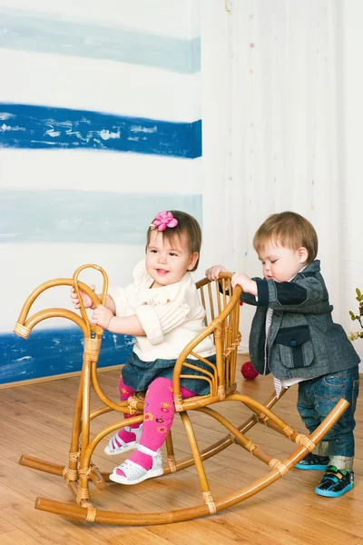 Little girl on a horse rocking chair — Stok fotoğraf