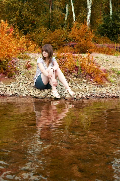 The sexual brunette on river bank — Stock Photo, Image