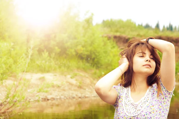 The sexual brunette against the river — Stock Photo, Image