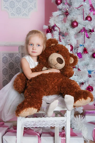 The girl at the Christmas fir-tree with gifts — Stock Photo, Image