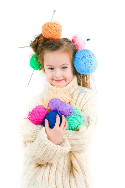 Girl with knitting spokes and balls of threads in hair — Stock Photo, Image