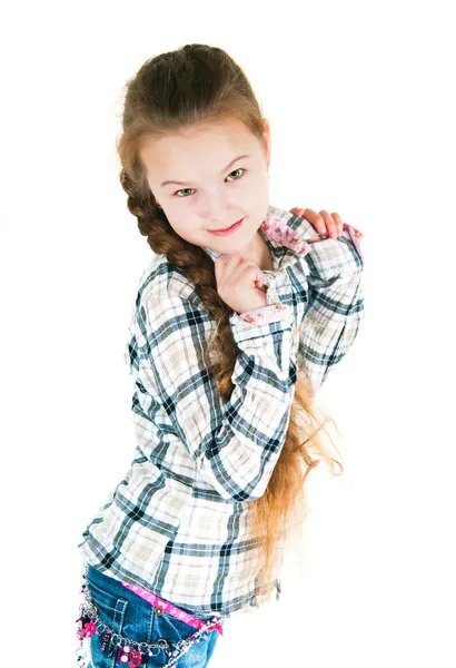 Girl with long braid in a plaid shirt and jeans — Stock Photo, Image