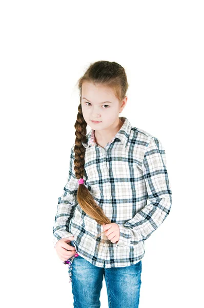 Girl with long braid in a plaid shirt and jeans — Stock Photo, Image