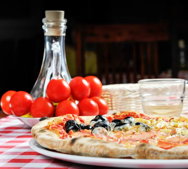 Pizza with ham, olives and other additives — Stock Photo, Image