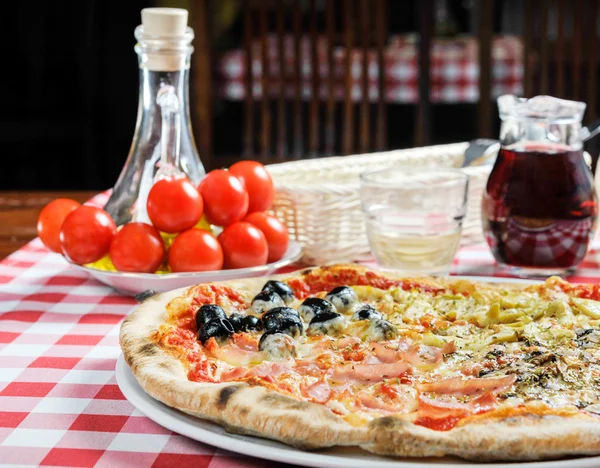 Pizza with ham, olives and other additives — Stock Photo, Image