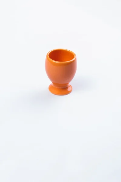 Orange egg cup on white — Stock Photo, Image