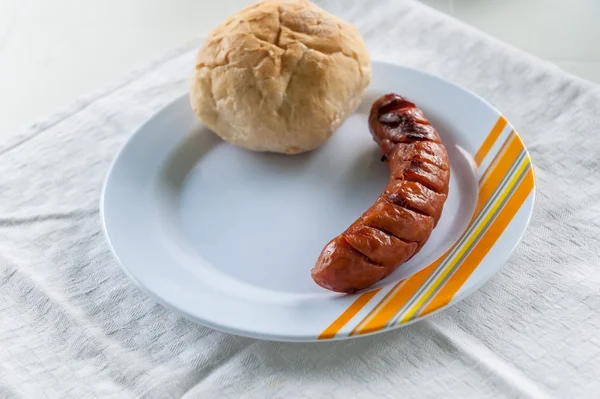 Grilled sausage and bun — Stock Photo, Image