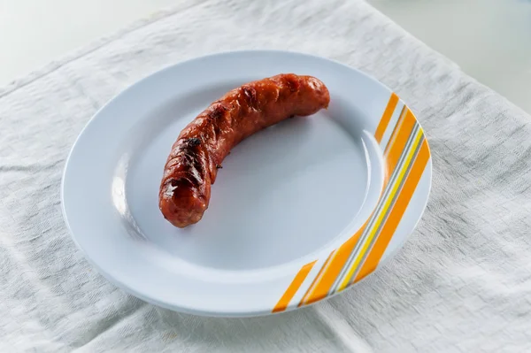 Grilled sausage on white plate — Stock Photo, Image