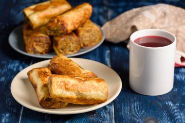 patties with mushrooms and a cup of red borscht