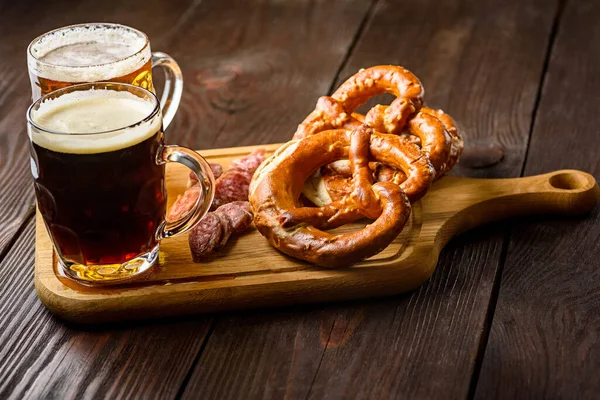 traditional mug of beer and pretzels - light or dark beer
