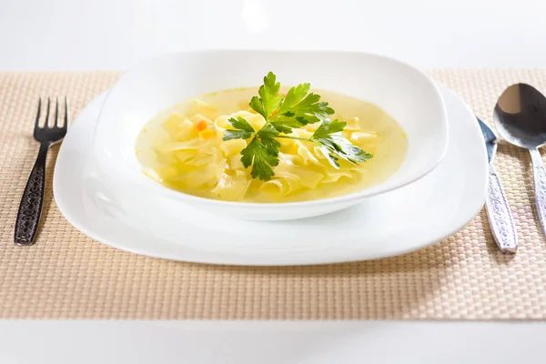 Broth cooked on chicken meat and vegetables, served with noodles.