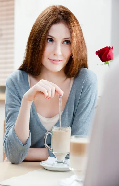 Woman with crimson rose at the cafe — Stock Photo, Image
