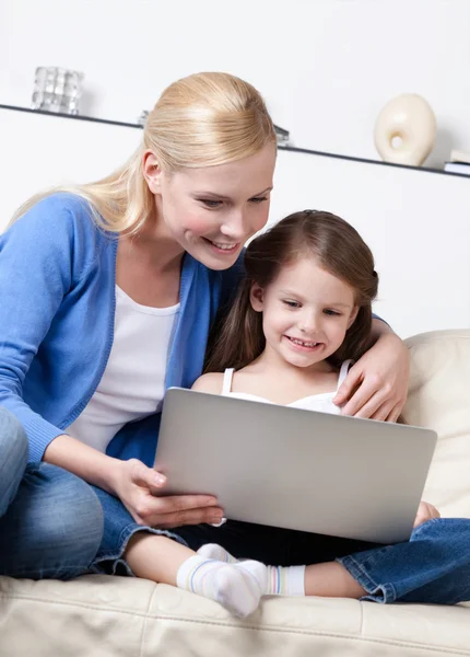 Little child surfs on the internet with her mum — Stock Photo, Image