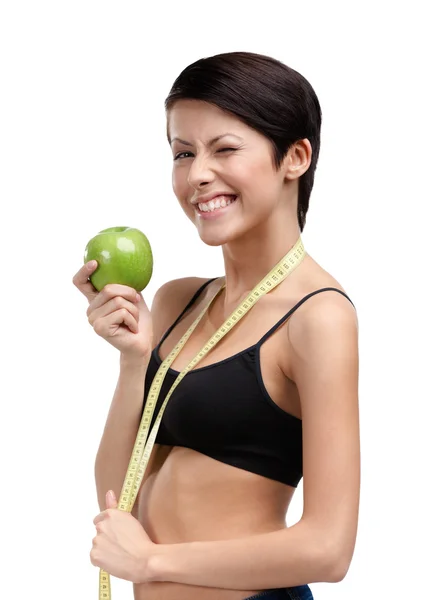 Vrouw met flexibele liniaal en groene appel — Stockfoto