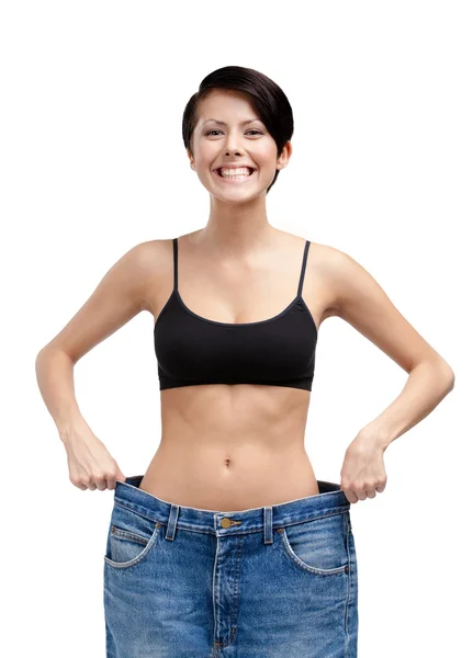 Slender woman wearing big jeans — Stock Photo, Image