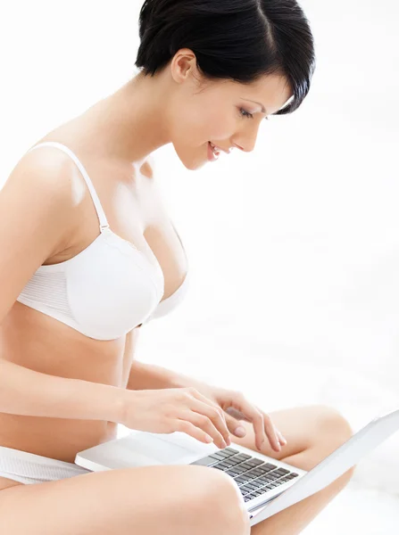 Woman in underwear is working on the laptop — Stock Photo, Image