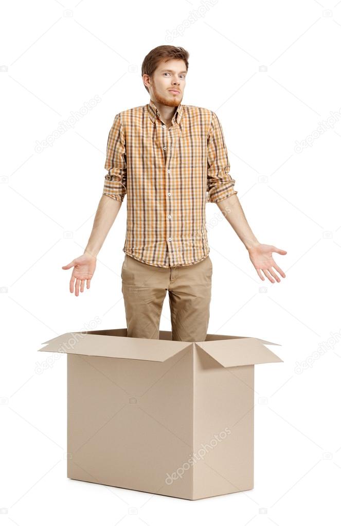Young man doesn't know why he is inside the box, isolated