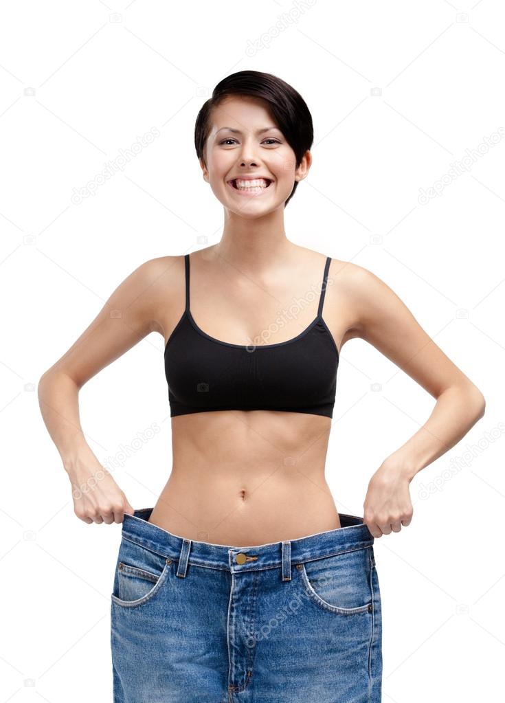 Slender woman wearing big jeans
