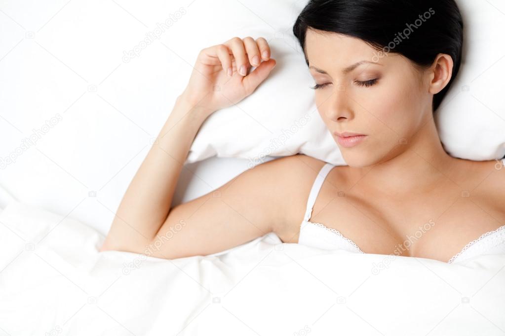 Sleeping sexy woman in the double bed