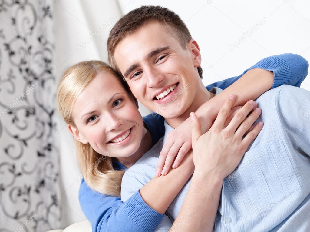 Happy couple sits on the couch