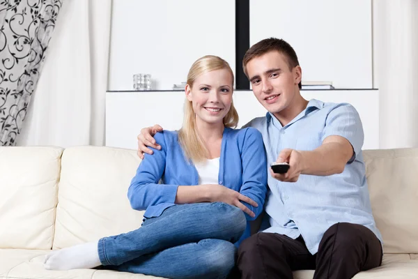 Man hands handset and is going to watch TV set — Stock Photo, Image
