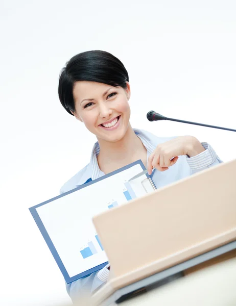 Smiley female speaker at the podium — Stock Photo, Image