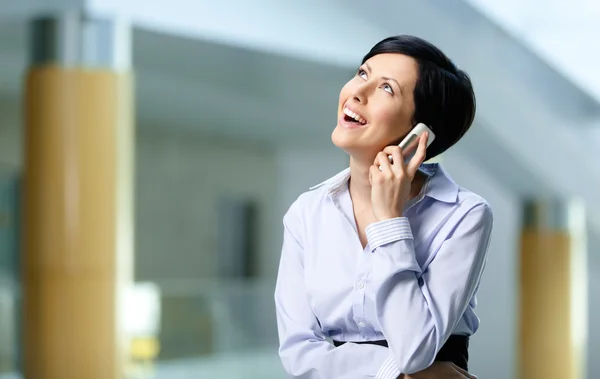 Businesswoman talks on cellphone — Stock Photo, Image