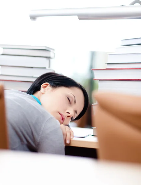 Tired female student sleeps at the table — Stock Photo, Image