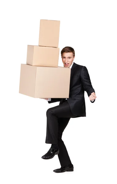 Manager holding pile of cardboard boxes — Stock Photo, Image