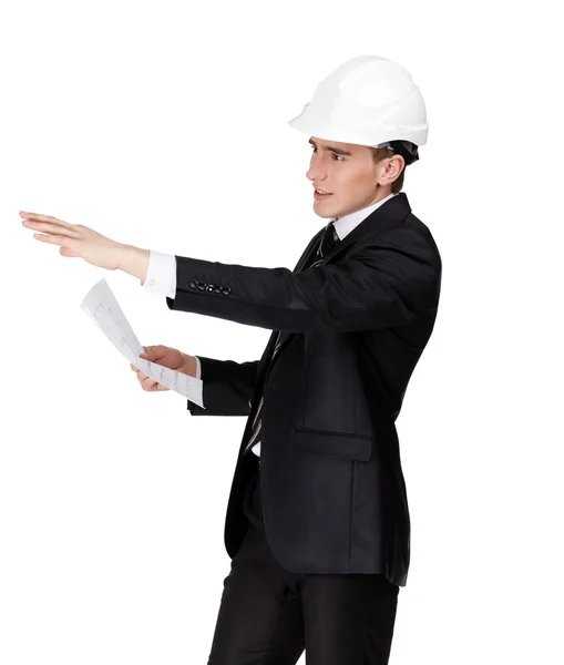 Businessman in helmet pointing at something — Stock Photo, Image