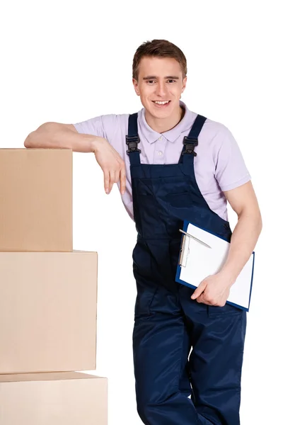 Young delivery man in overalls with boxes — Stock Photo, Image