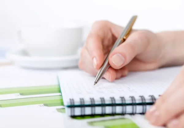 Close up shot of hand writing in the notebook — Stock Photo, Image