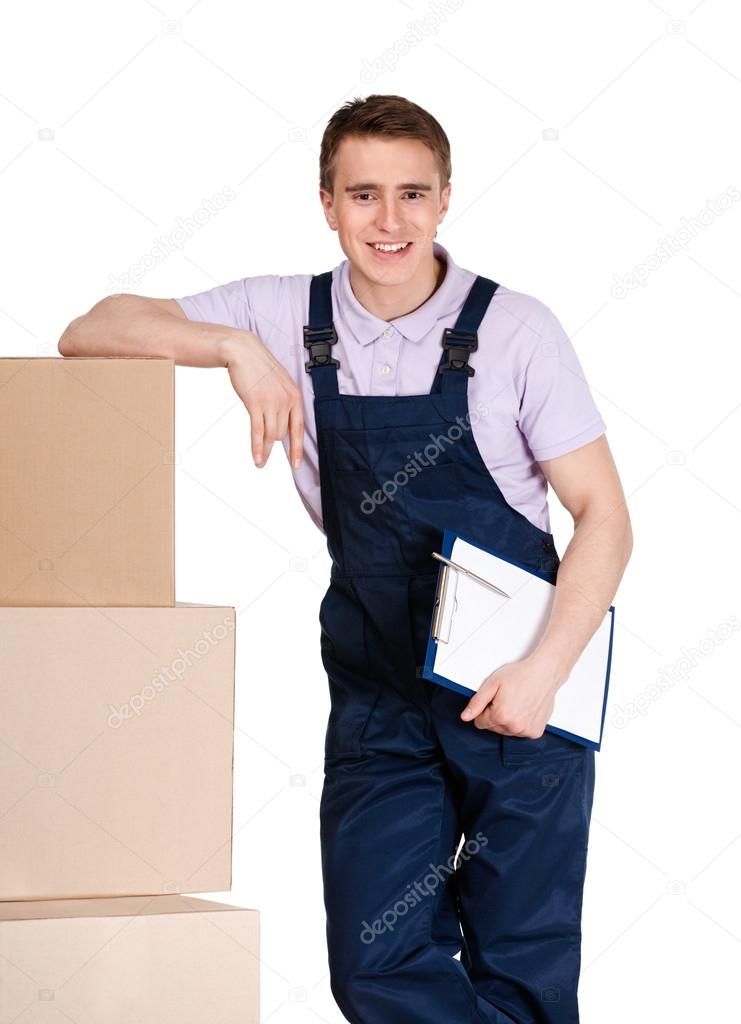 Young delivery man in overalls with boxes