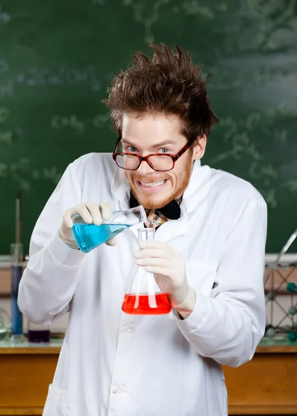 Безумный профессор наливает голубую жидкость — стоковое фото