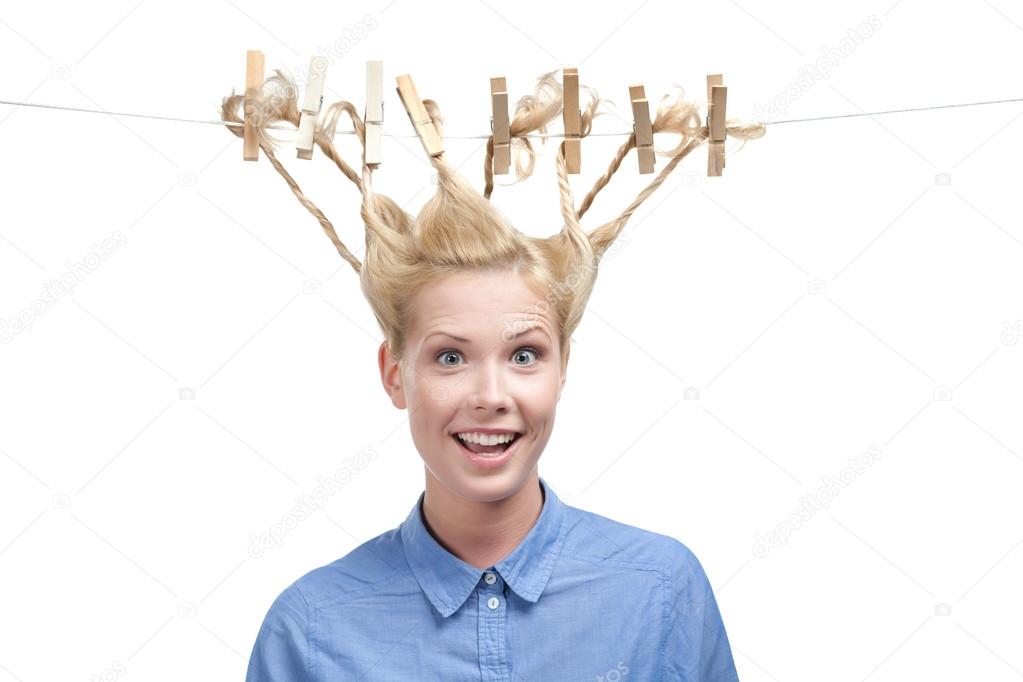 Woman with creative hairstyle of clothespins